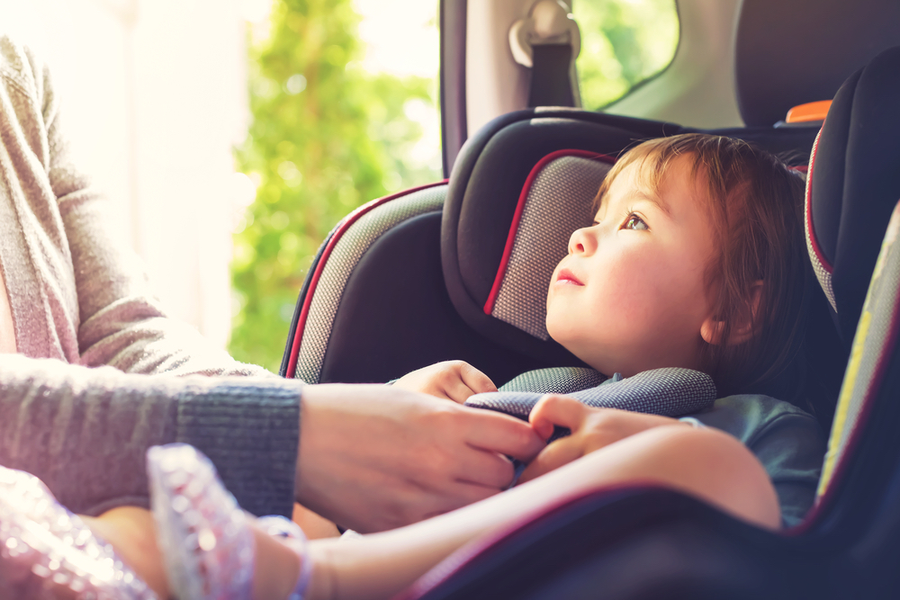 Toddler girl in her car seat