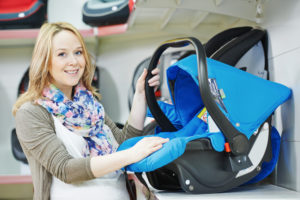 Travel Car Seat Expert - A woman holding a car seat on a plane.