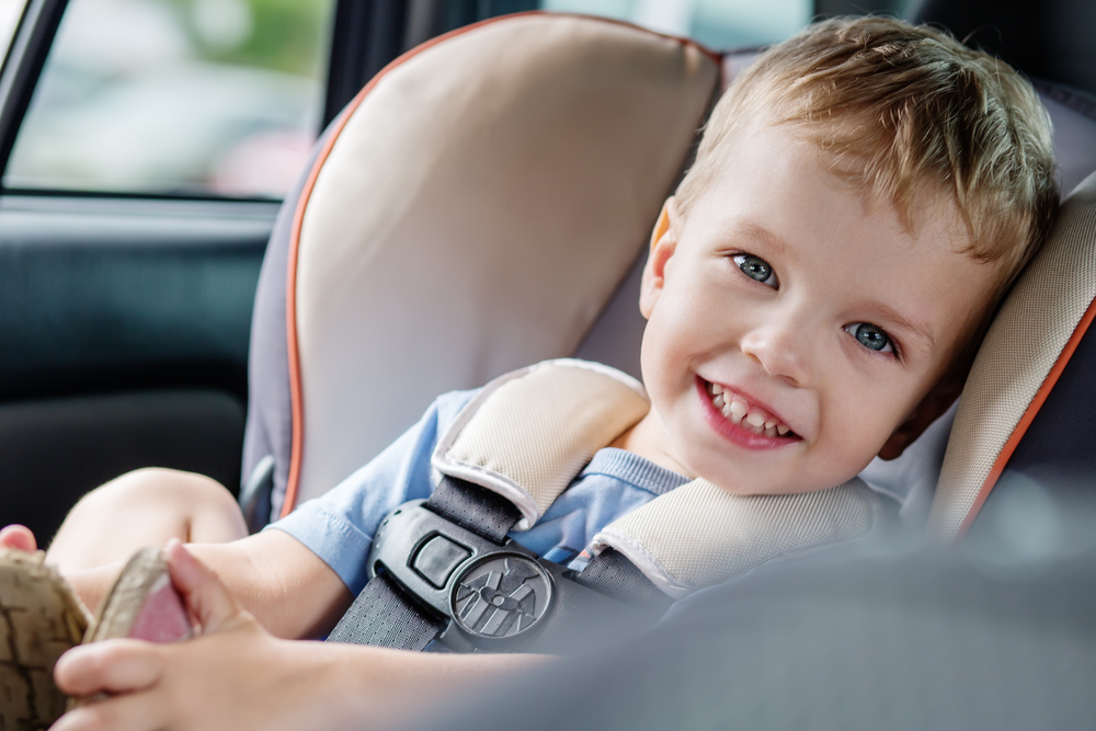 Travel Car Seat Expert - A child securely fastened in a travel car seat.