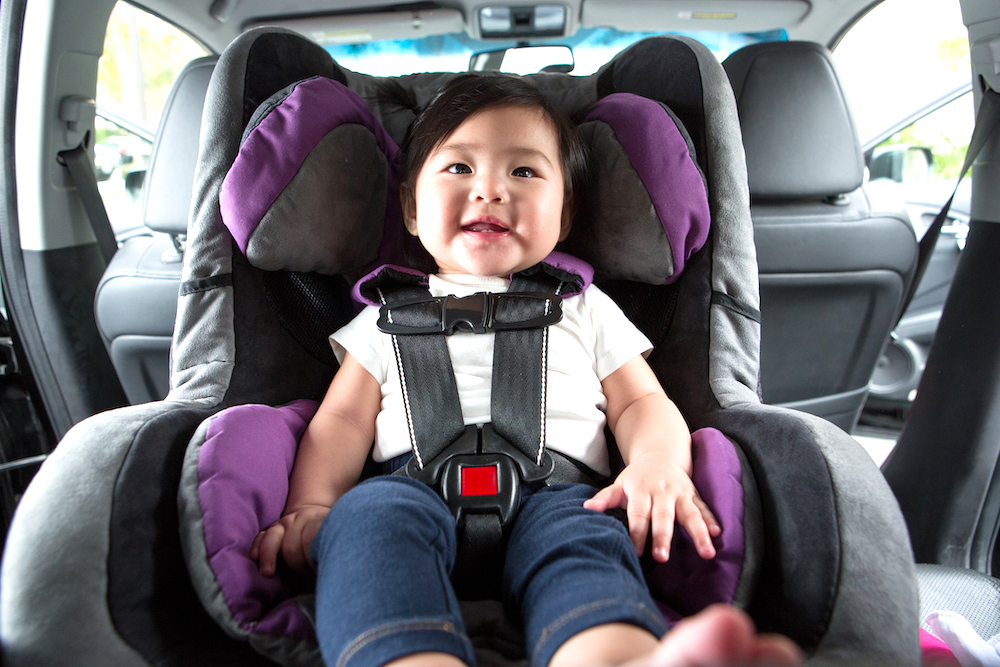 Travel Car Seat Expert - A baby securely strapped in a travel car seat.