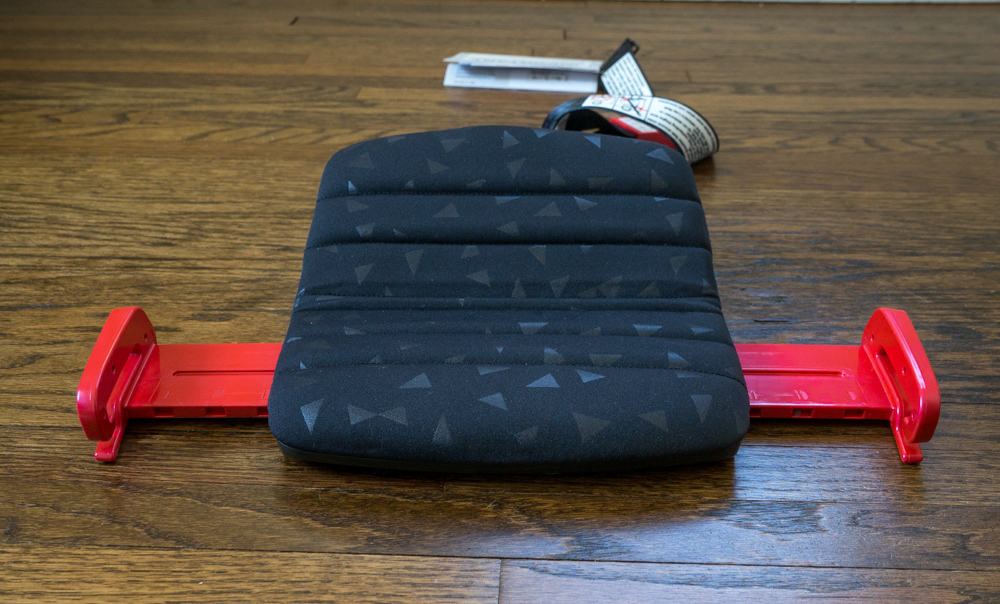 Travel Car Seat Expert - A black and red car seat on a wooden floor.