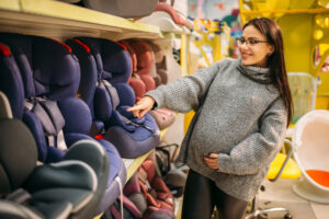 Travel Car Seat Expert - A pregnant woman looking at the best travel car seat in a store.