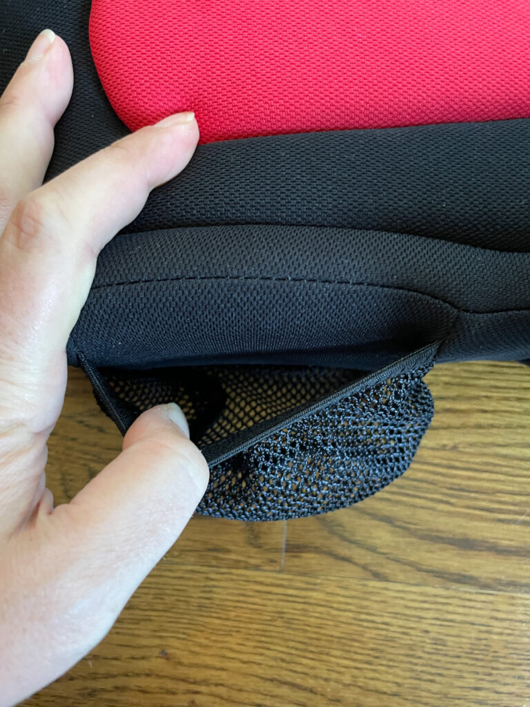 Travel Car Seat Expert - A person holding a red and black laptop bag.