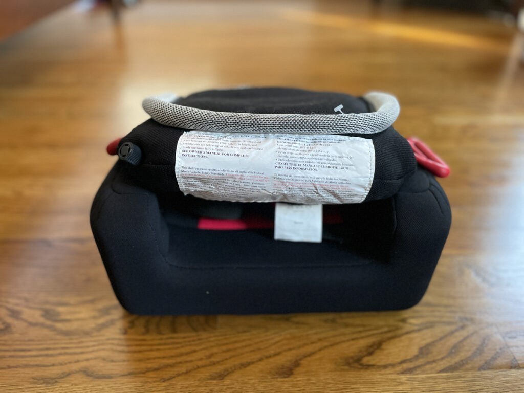 Travel Car Seat Expert - A baby car seat on a wooden floor.